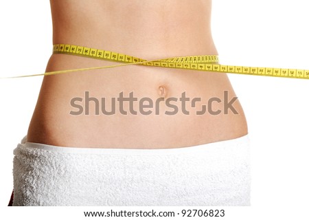 Front view of a fit belly closeup with a measure round the waist, over white.