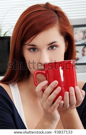 Beautiful lady is drinking coffee at home