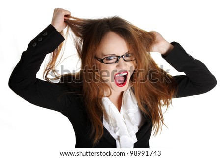 Stressed business woman is going crazy pulling her hair in frustration.