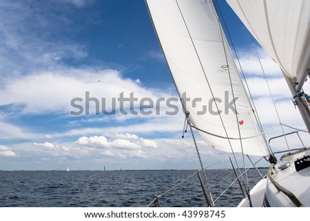 View from a sailing yacht, sailing in a nice breeze on a blue lake Grevelingen