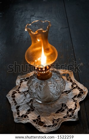Flame of an ancient oil lamp in the night