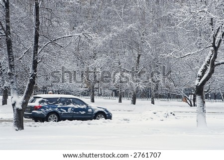 Car during a snowfall in town-snowdrift in city creates greater problems for automobile movement