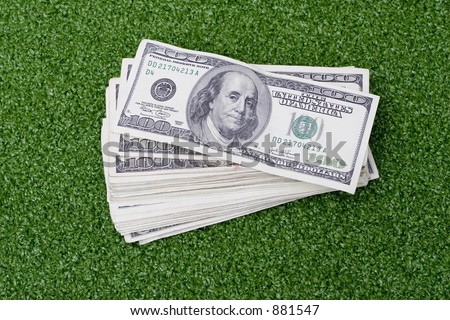 stack of green money on green background