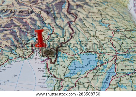 Fredrikstad marked with red pushpin on map. Selected focus on Fredrikstad and bright red pushpin. Pushpin is in an angle. Southern parts of Norway and Sweden can be seen on map.