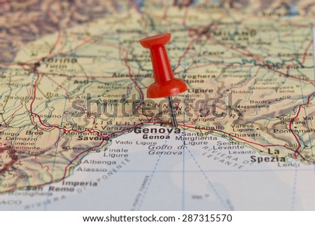 Genova (Genoa) marked with red pushpin on map. Selected focus on Genova and pushpin. Pushpin is in an angle.