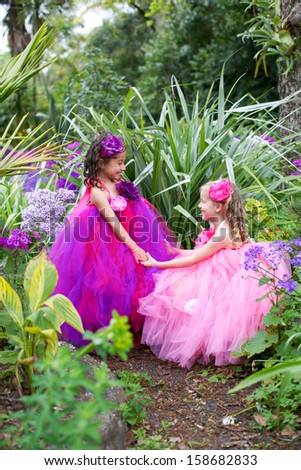 Pretty girls dressed as fairies in the garden.