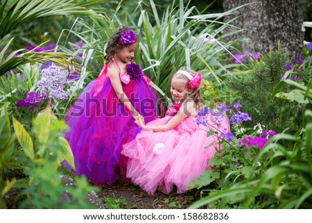 Pretty girls dressed as fairies in the garden.