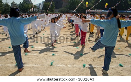 Korean school children doing exercise drills with their teachers