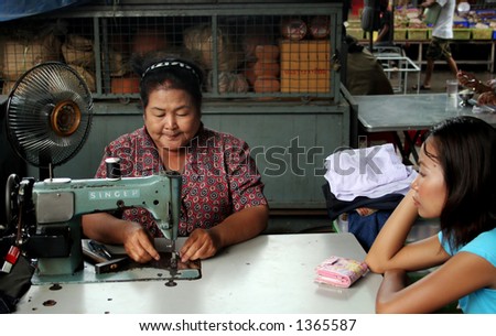 Thai woman sewing on an old Singer machine in a factory in Rayong, Thailand