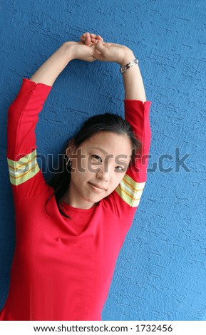Beautiful young Korean woman with her arms up