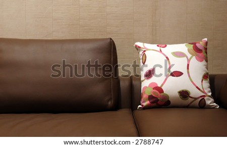 Pillow on a leather sofa - home interiors