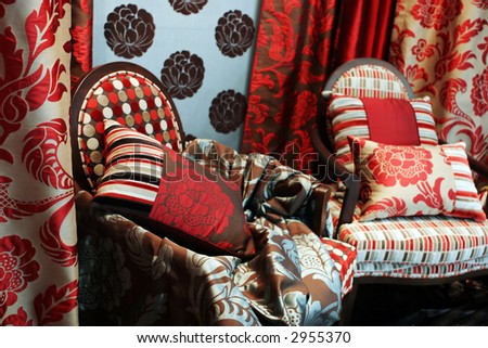 Luxurious red arm chairs with satin pillows - home interiors