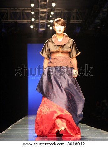 Asian model on the catwalk in traditional South Korean dress (hanbok)