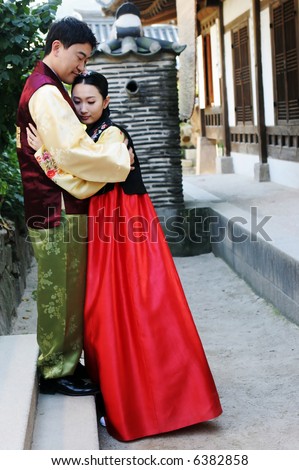 South Korean man and woman in traditional dress - travel and tourism.