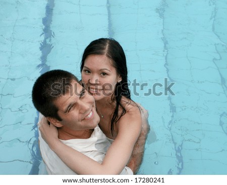 Bride and groom in the swimming pool - trash the dress trend.