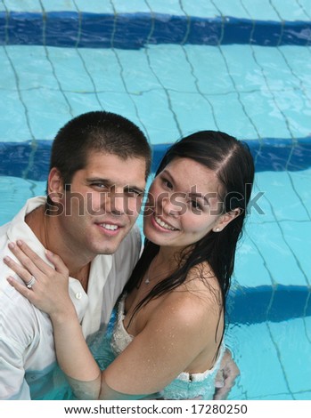 Bride and groom in the swimming pool - trash the dress trend.