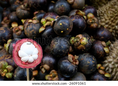 Close-up of mangosteen at a fruit stall.