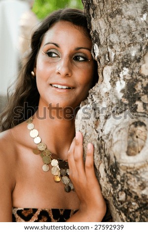 Portrait of a beautiful brunette woman in a leopard print dress.