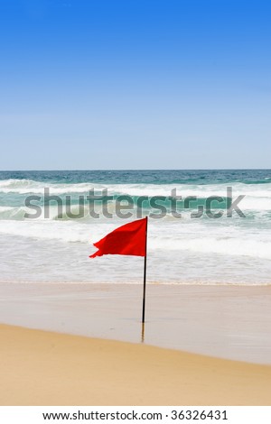 Red flag at the beach to warn swimmers to be careful when swimming.