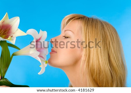 the young blond woman with madonna lily on blue background