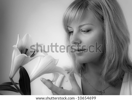 young blond woman with madonna lily, black and white