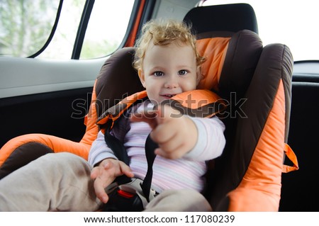 Cute baby  enjoying a road trip in a baby car seat
