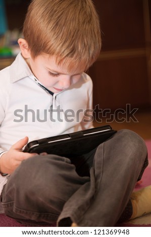 Cute little boy study with digital tablet computer