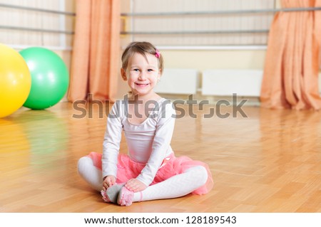 Cute little ballerina training at ballet class