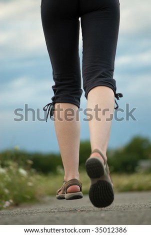 Jogging legs closeup. Female is jogging in city park