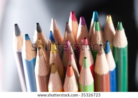 Twenty three pencils on black and white background