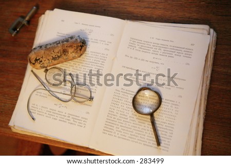 Phisics textbook., magnifying glass.Glass case.