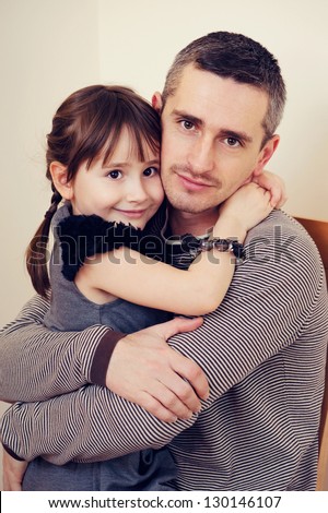 Father and daughter hugging and smiling