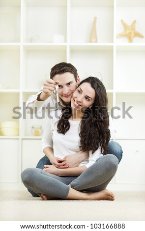 Young couple with keys to their new home