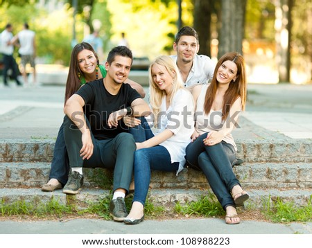 Group of five young student friends outdoors