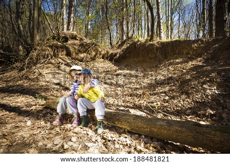 Two little children resting in forest