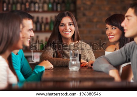 Group of young people in a bar.