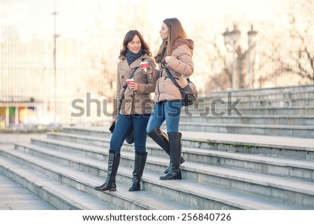 Two young women leaving office building