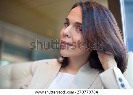 Portrait of beautiful businesswoman sitting in a office or in a cafe on a coffee break