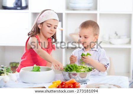 Cute little brother and sister preparing healthy vegan meal