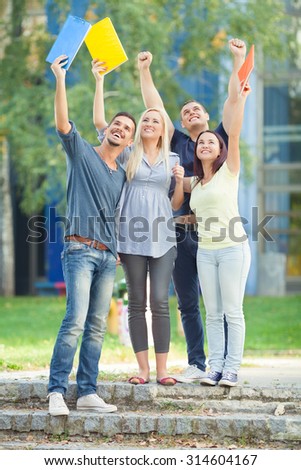 Group of happy students celebrating their success