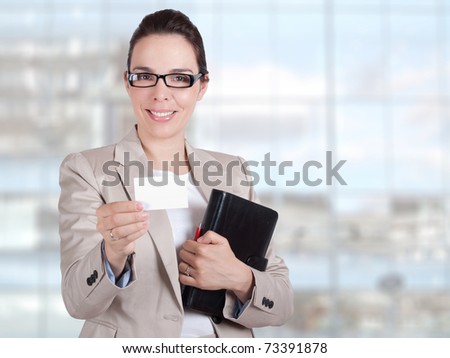 Beautiful young business woman holding a business card