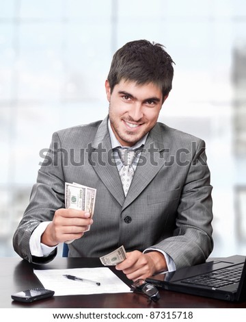 Young and handsome business man giving money with happy face