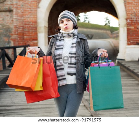 Attractive girl with shopping bags for holidays