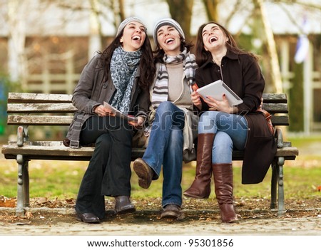 Three beautiful female friends laughing