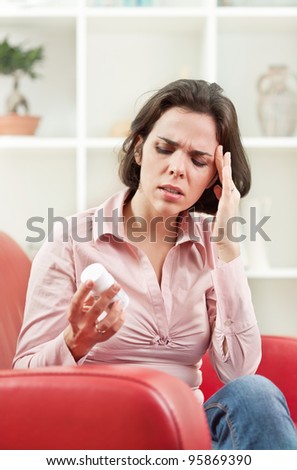 Woman with headache taking medicine