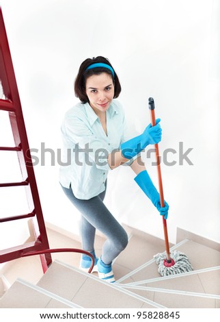 Beautiful woman cleaning stairs