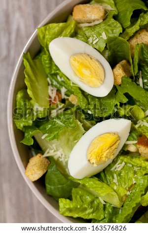 Caesar salad with eggs, lettuce, croutons and parmesan