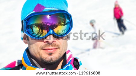 Clouseup portrait of young man with ski goggles in the Zillertal Arena, Austria