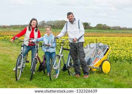 Family of four with bicycle on a spring day in Holland