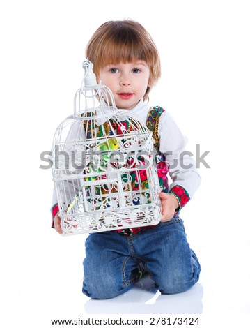 Little cute boy with a parrot in a cage. Isolated on the white background